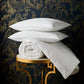 Down pillows and duvet on side table, White