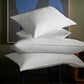 stack of down pillows on chair, White