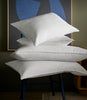 stack of down pillows on chair, White