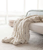 Mila Faux Fur Throw draped on couch, Pearl