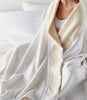 Favorite Cotton Blanket wrapped around woman on bed, White