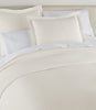 Mia Stonewashed Matelassé Shams on bed, Pearl