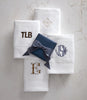 Monogrammed hand towels folded on counter, White