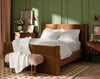 all white bedding on burnt orange velvet bed in green bedroom