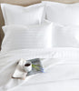 Montauk Matelassé Coverlet on bed, White