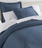 Oxford Matelassé Shams on bed Cadet Blue