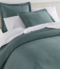 Oxford Matelassé Shams on bed Pine